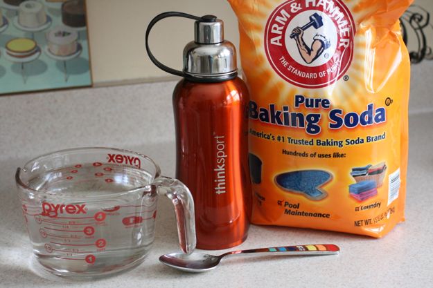 Photo of water bottle, baking soda, and tools for cleaning.