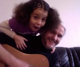 Photo of a father and daughter singing about joy.